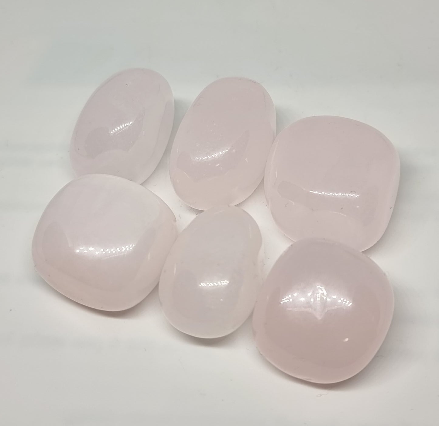 mangano calcite tumbles with amazing pink colours with quartz hues taken at Mind Soul Sync crystal shop in Australia.